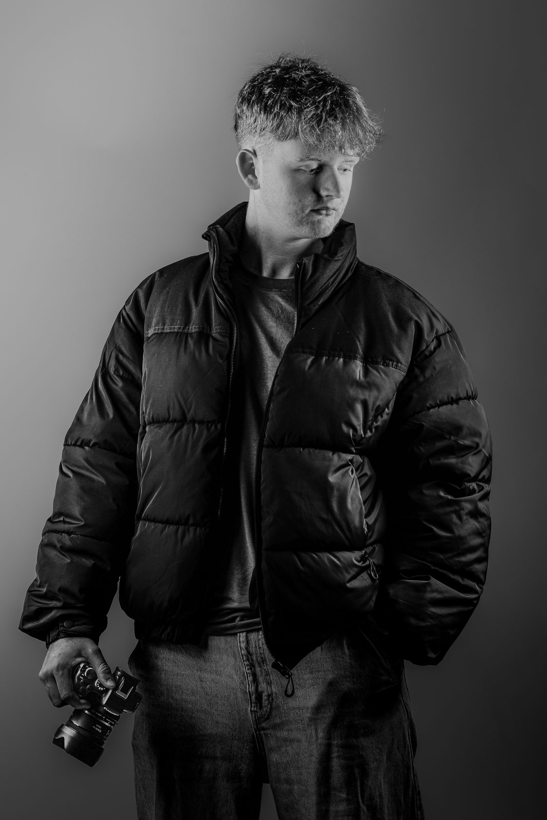 Adam Steele, photographer, holding his camera